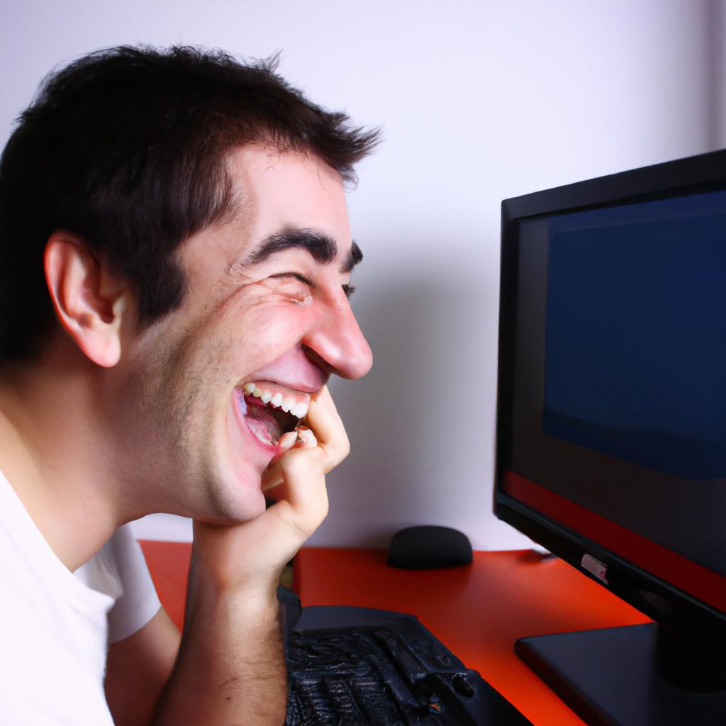 Person laughing at computer screen